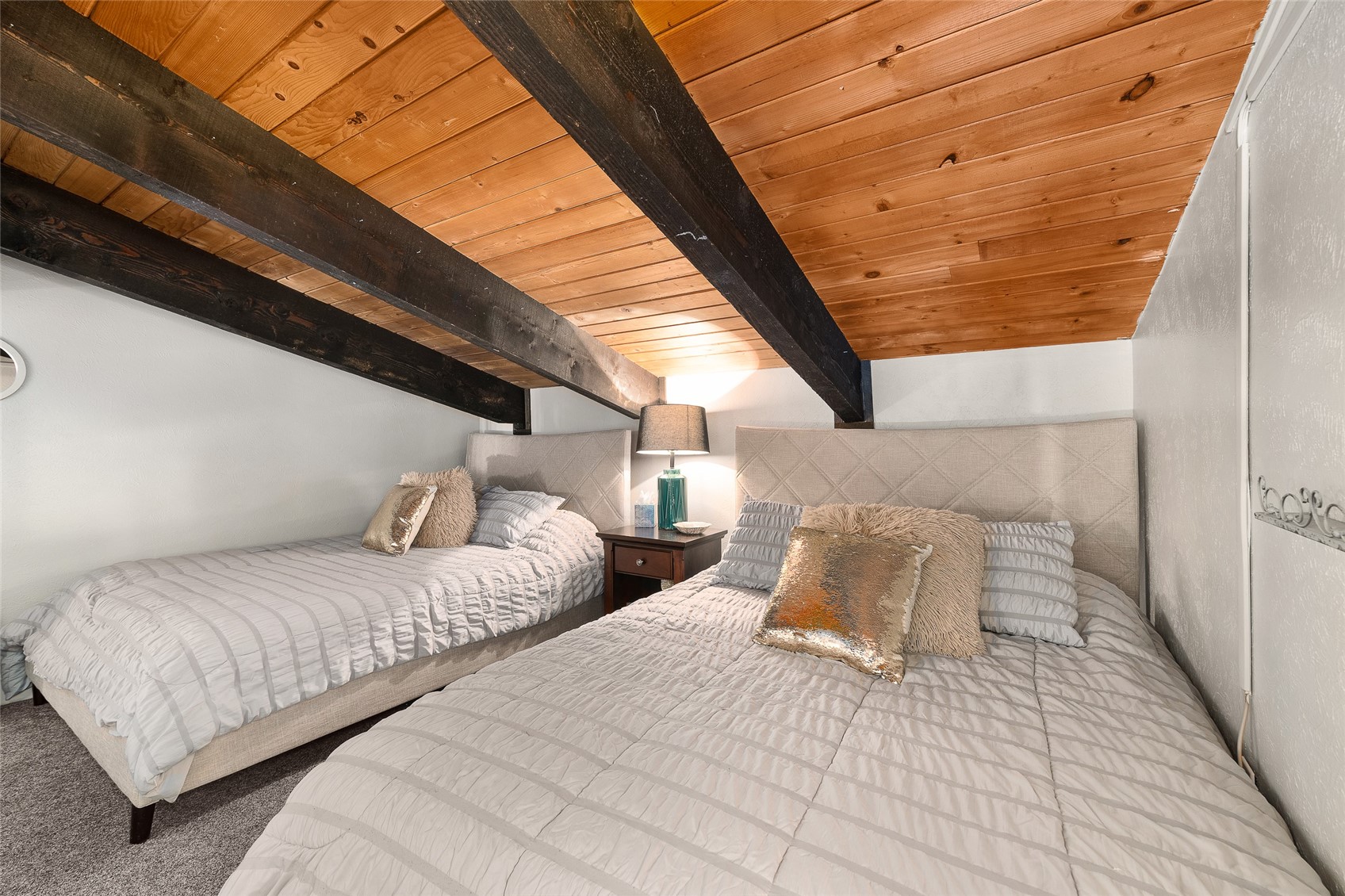 1335 Walton Creek Road, Unit 35 Steamboat Springs, CO 80487 - Photo 37 of 48 a bedroom with two beds and a night stand