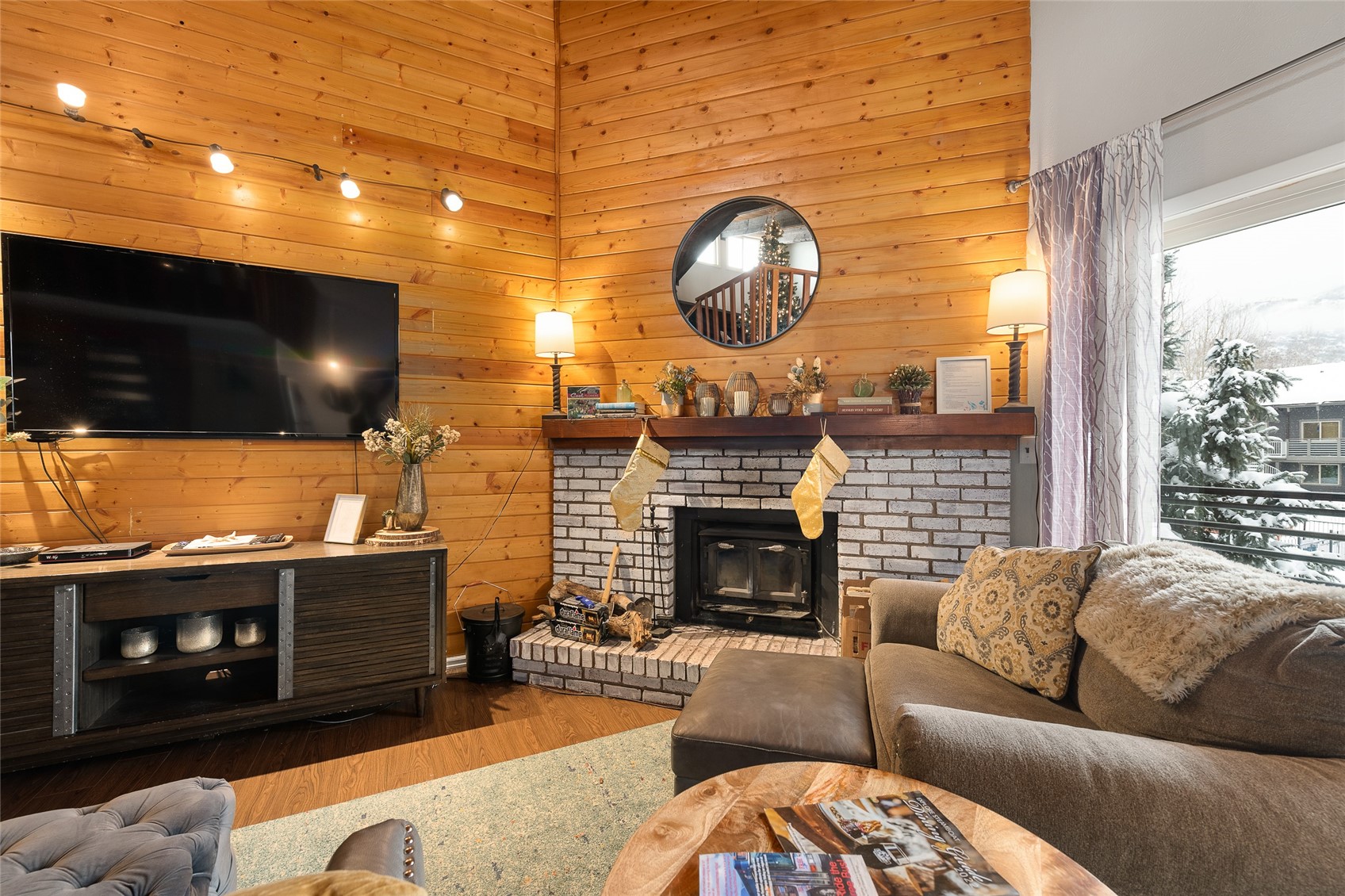 1335 Walton Creek Road, Unit 35 Steamboat Springs, CO 80487 - Photo 4 of 48 a living room with furniture a flat screen tv and a fireplace