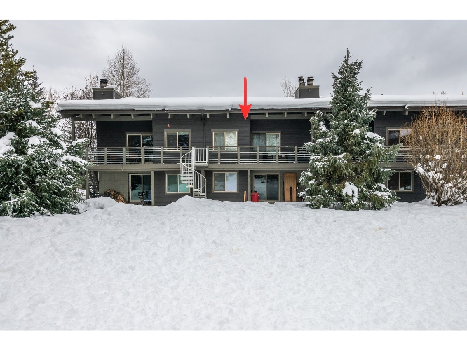 1335 Walton Creek Road, Unit 35 Steamboat Springs, CO 80487 - Photo 45 of 48 a view of a house with a balcony and potted plants