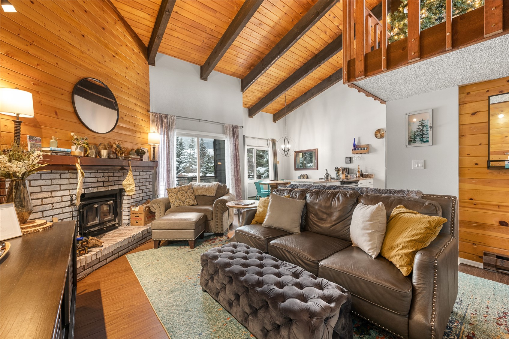 1335 Walton Creek Road, Unit 35 Steamboat Springs, CO 80487 - Photo 6 of 48 a living room with furniture a fireplace and a flat screen tv