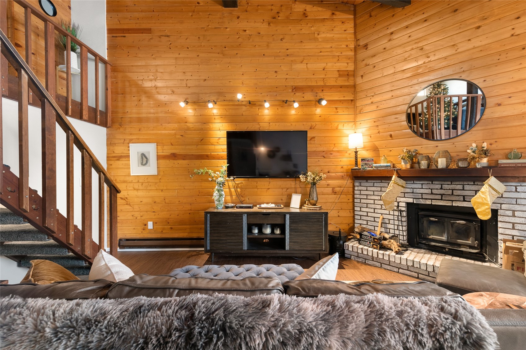 1335 Walton Creek Road, Unit 35 Steamboat Springs, CO 80487 - Photo 7 of 48 a living room with fireplace furniture and a flat screen tv