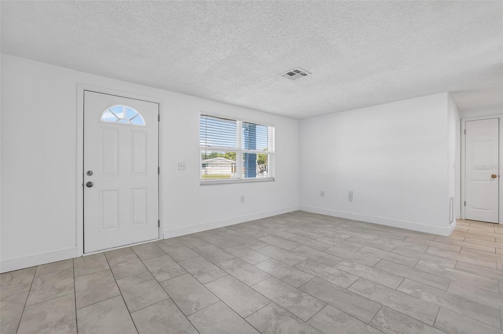 10914 Leeds Road Port Richey, FL 34668 - Photo 13 of 24 a view of an empty room with window and closet area