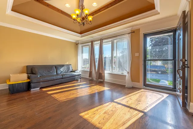 a living room with furniture and a chandelier
