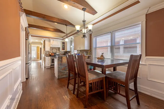 a dining room with furniture window and wooden floor