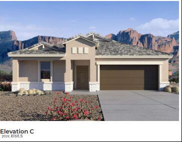 3023 Shepperd Avenue Apache Junction, AZ 85120 - Photo 2 of 3 a front view of a house with a garden