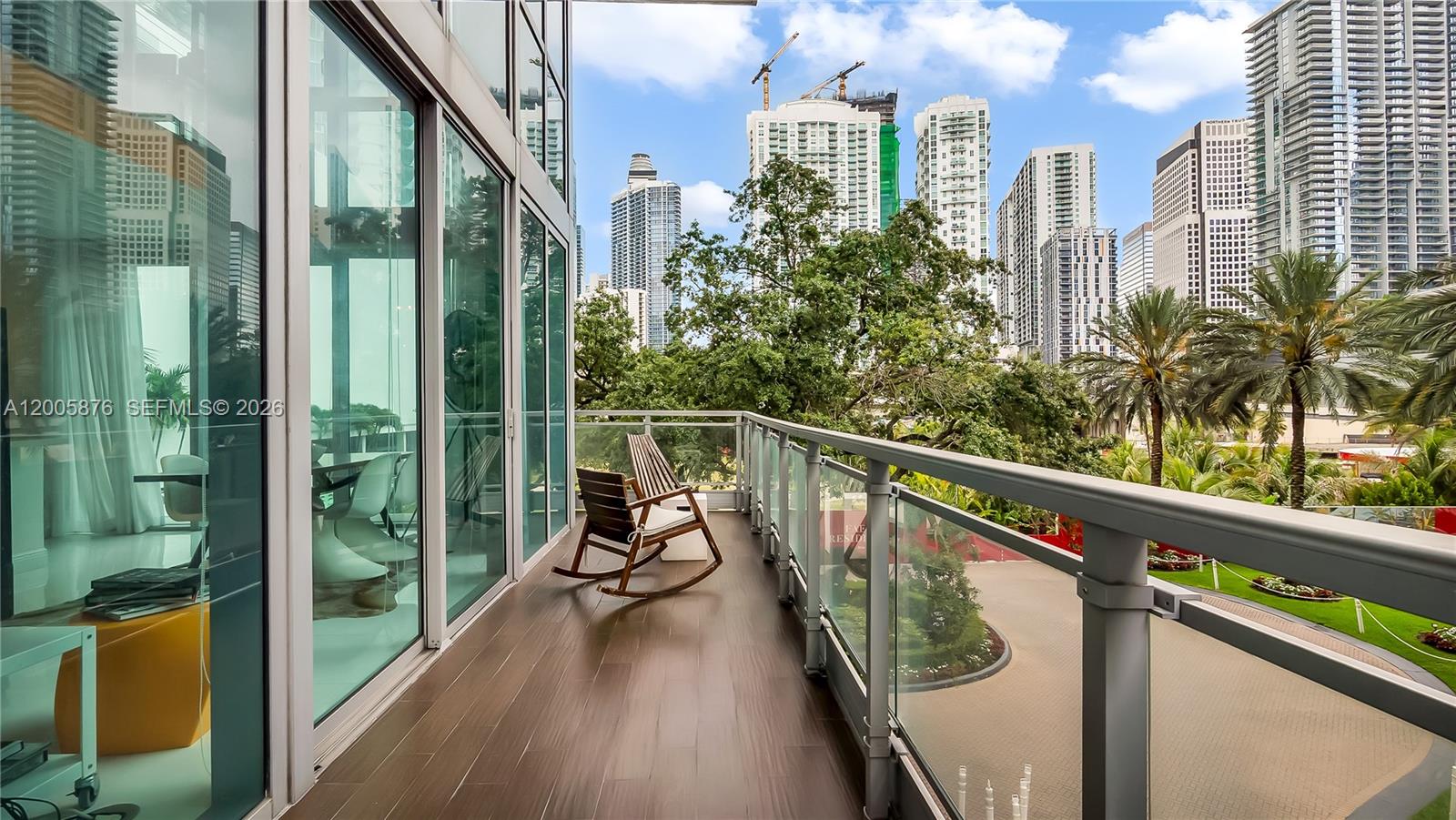 90 Southwest 3rd Street, Unit TH 308 Miami, FL 33130 - Photo 11 of 28 a view of a balcony with chairs and wooden floor