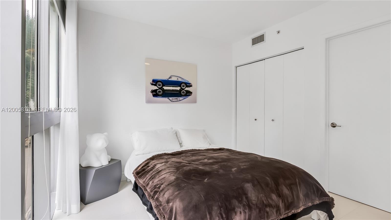 90 Southwest 3rd Street, Unit TH 308 Miami, FL 33130 - Photo 13 of 28 a bedroom with a bed and a table