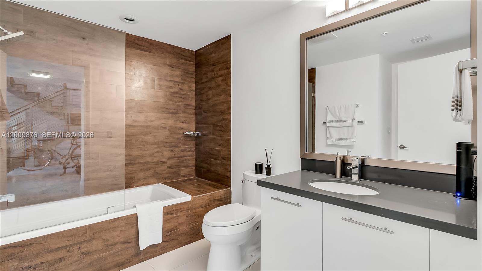 90 Southwest 3rd Street, Unit TH 308 Miami, FL 33130 - Photo 14 of 28 a bathroom with a double vanity sink toilet and shower