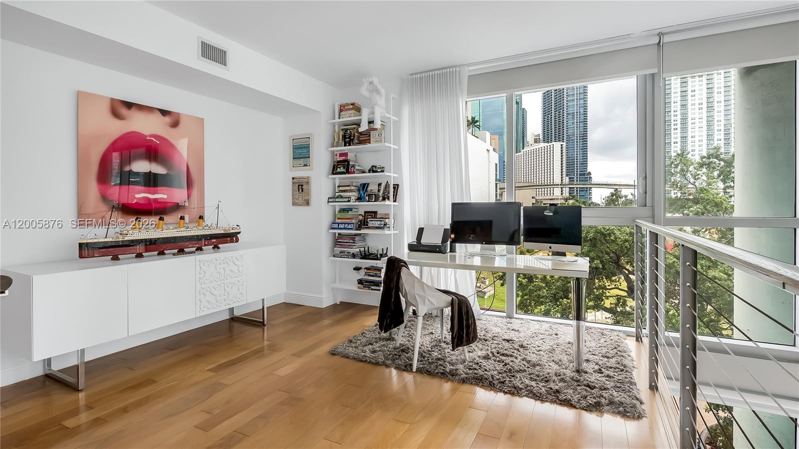 90 Southwest 3rd Street, Unit TH 308 Miami, FL 33130 - Photo 15 of 28 a living room with furniture a flat screen tv and a floor to ceiling window