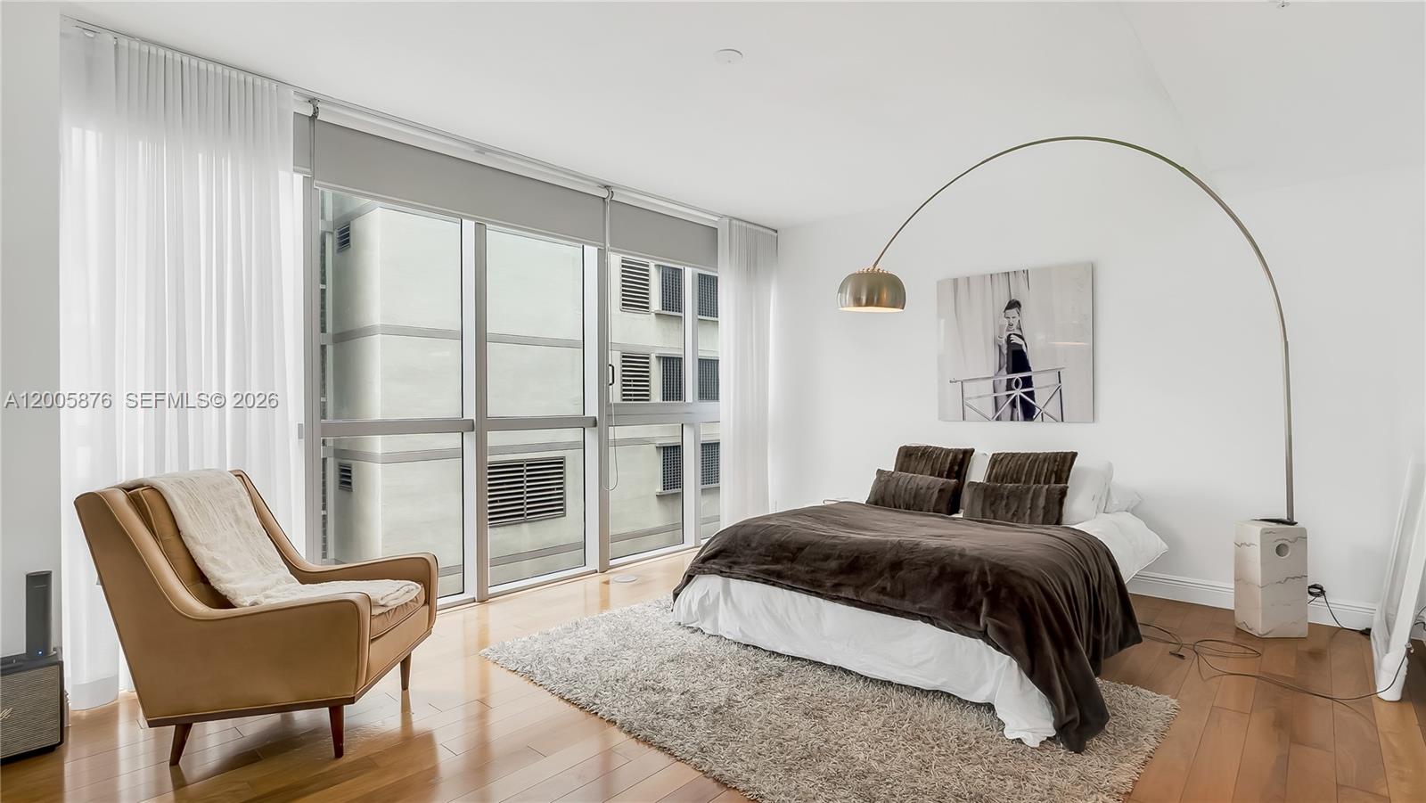 90 Southwest 3rd Street, Unit TH 308 Miami, FL 33130 - Photo 18 of 28 a bedroom with a bed and a chair