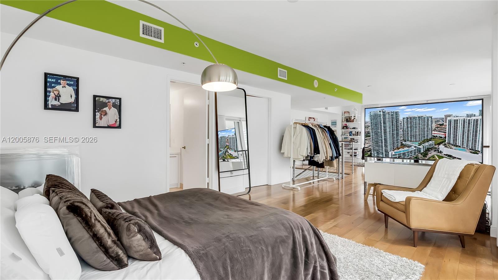 90 Southwest 3rd Street, Unit TH 308 Miami, FL 33130 - Photo 19 of 28 a bedroom with a bed and a chair
