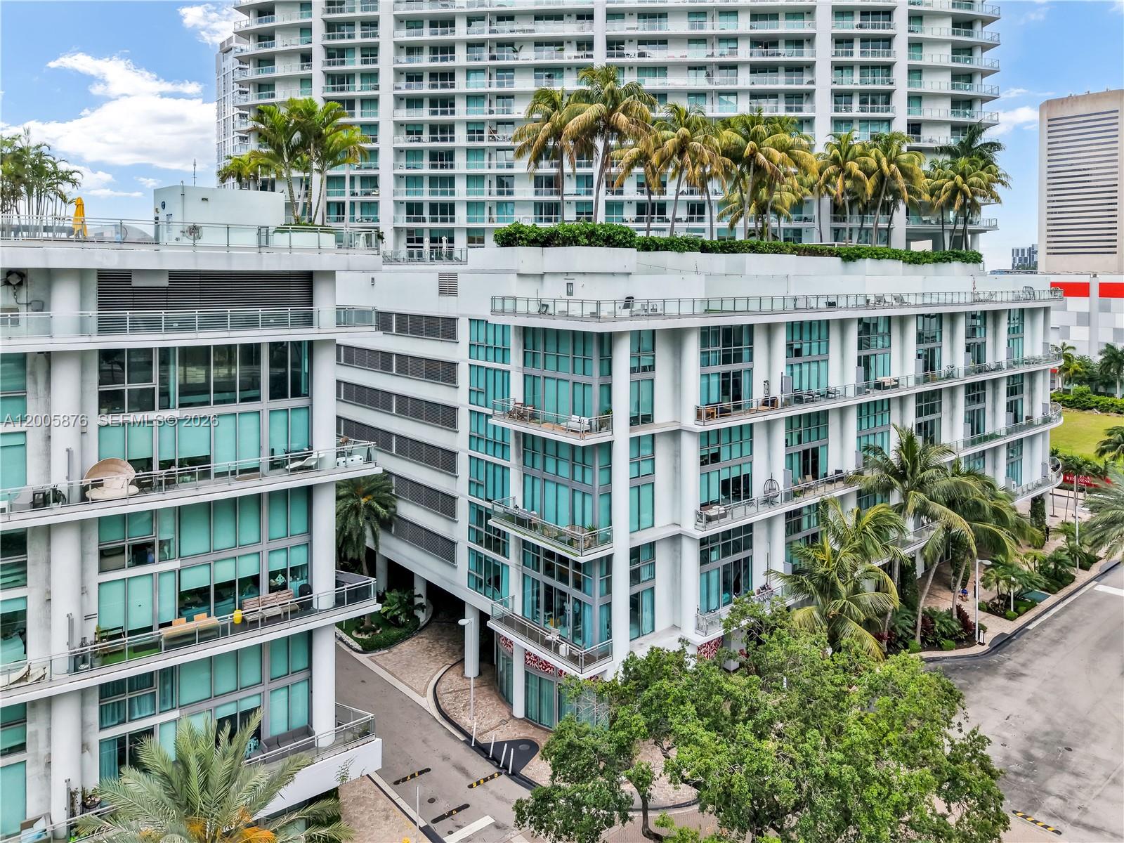 90 Southwest 3rd Street, Unit TH 308 Miami, FL 33130 - Photo 21 of 28 a front view of a building with a garden