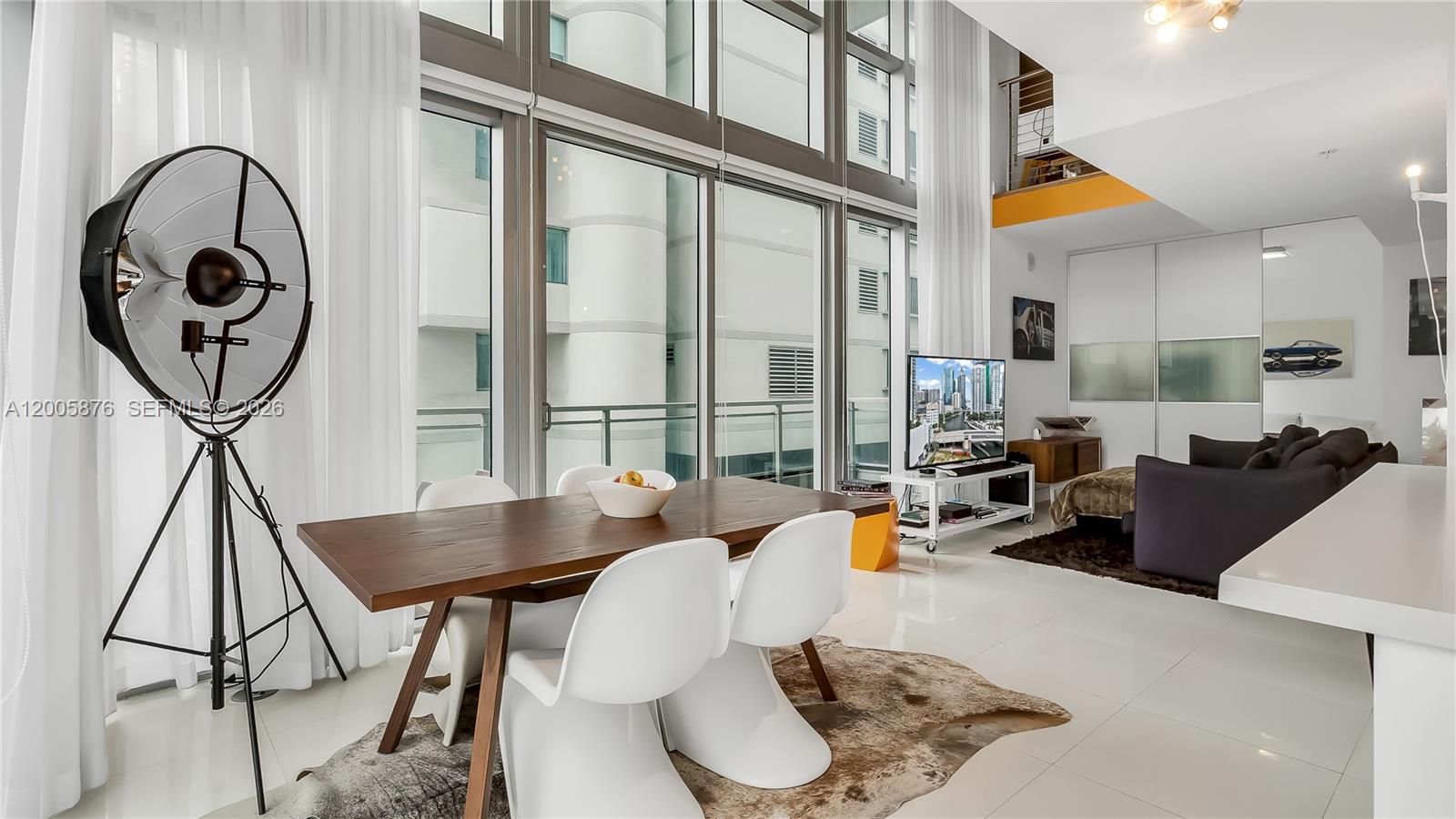 90 Southwest 3rd Street, Unit TH 308 Miami, FL 33130 - Photo 6 of 28 a living room with furniture a rug and a floor to ceiling window