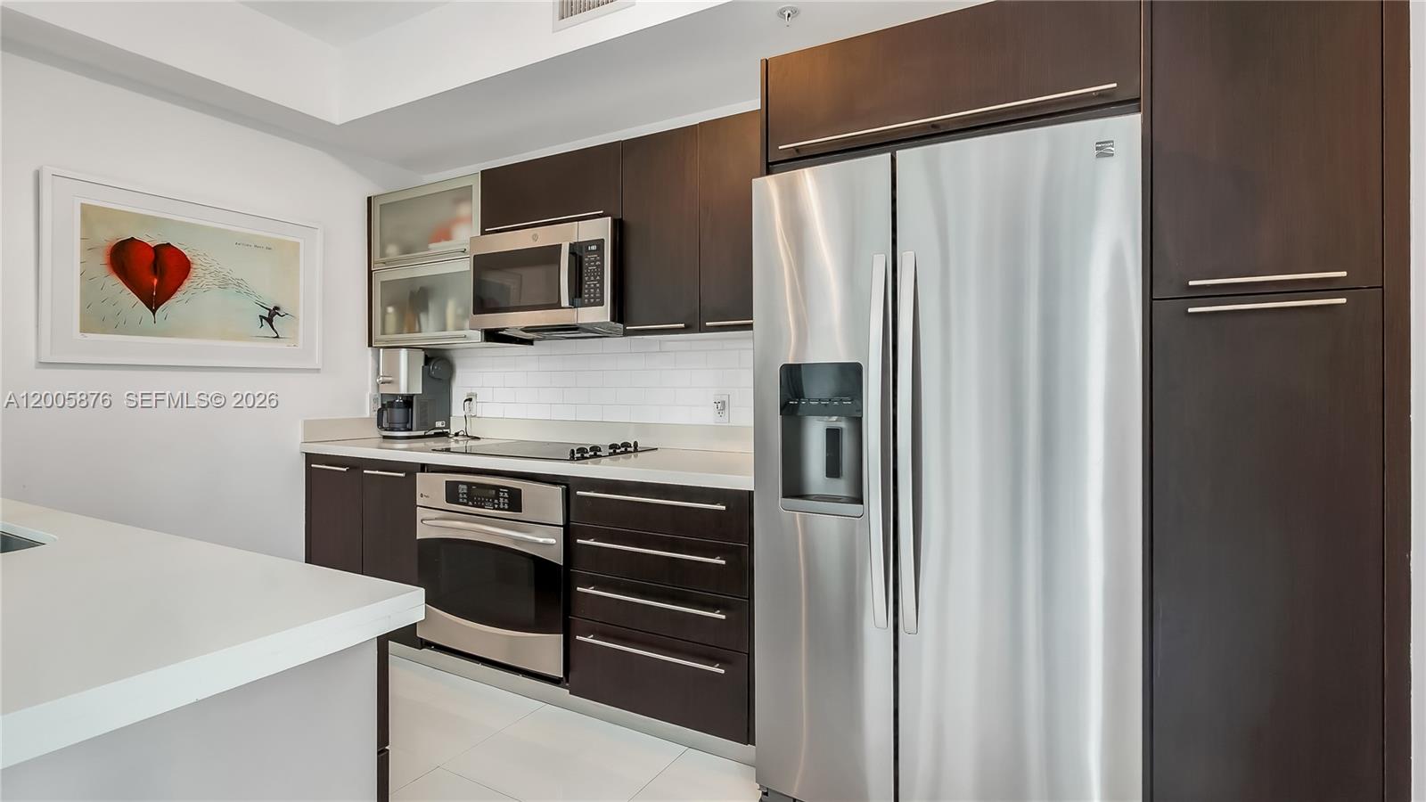 90 Southwest 3rd Street, Unit TH 308 Miami, FL 33130 - Photo 7 of 28 a kitchen with stainless steel appliances a refrigerator sink and microwave