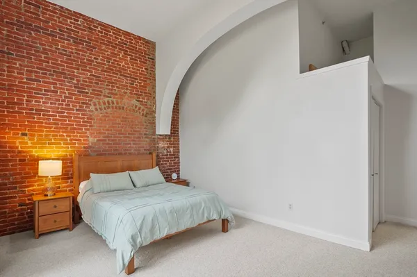 a bedroom with a bed and dresser