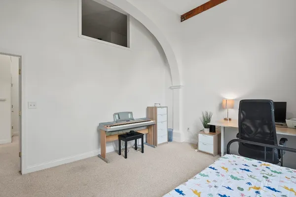 a bedroom with a bed and a television