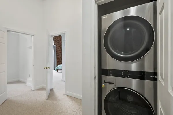 a view of a hallway with washer and dryer