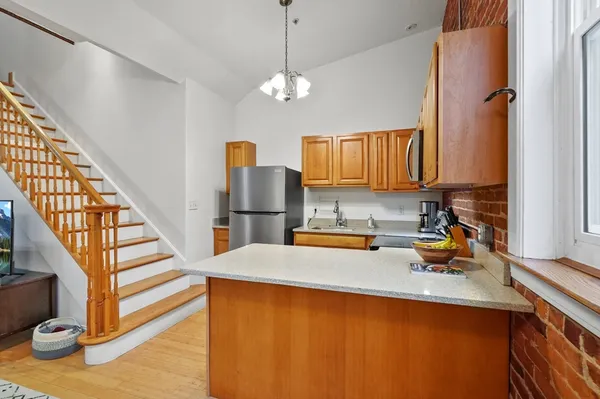 a kitchen with a refrigerator and a sink