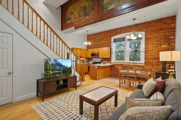 a living room with furniture a rug and a window