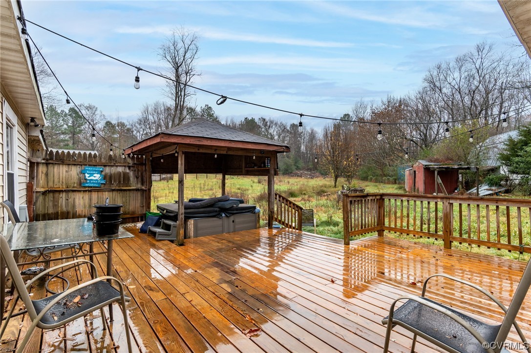 2949 Broadstreet Road Gum Spring, VA 23065 - Photo 21 of 21 a view of a roof deck with table and chairs under an umbrella with wooden floor