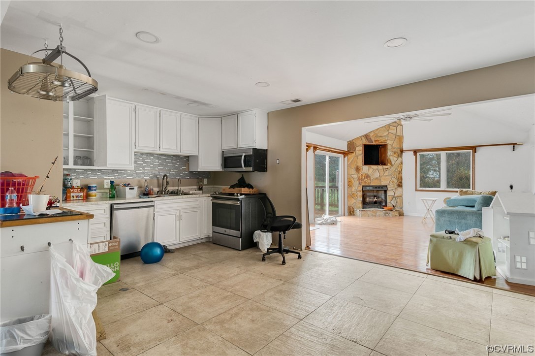 2949 Broadstreet Road Gum Spring, VA 23065 - Photo 6 of 21 a kitchen with a refrigerator and white cabinets
