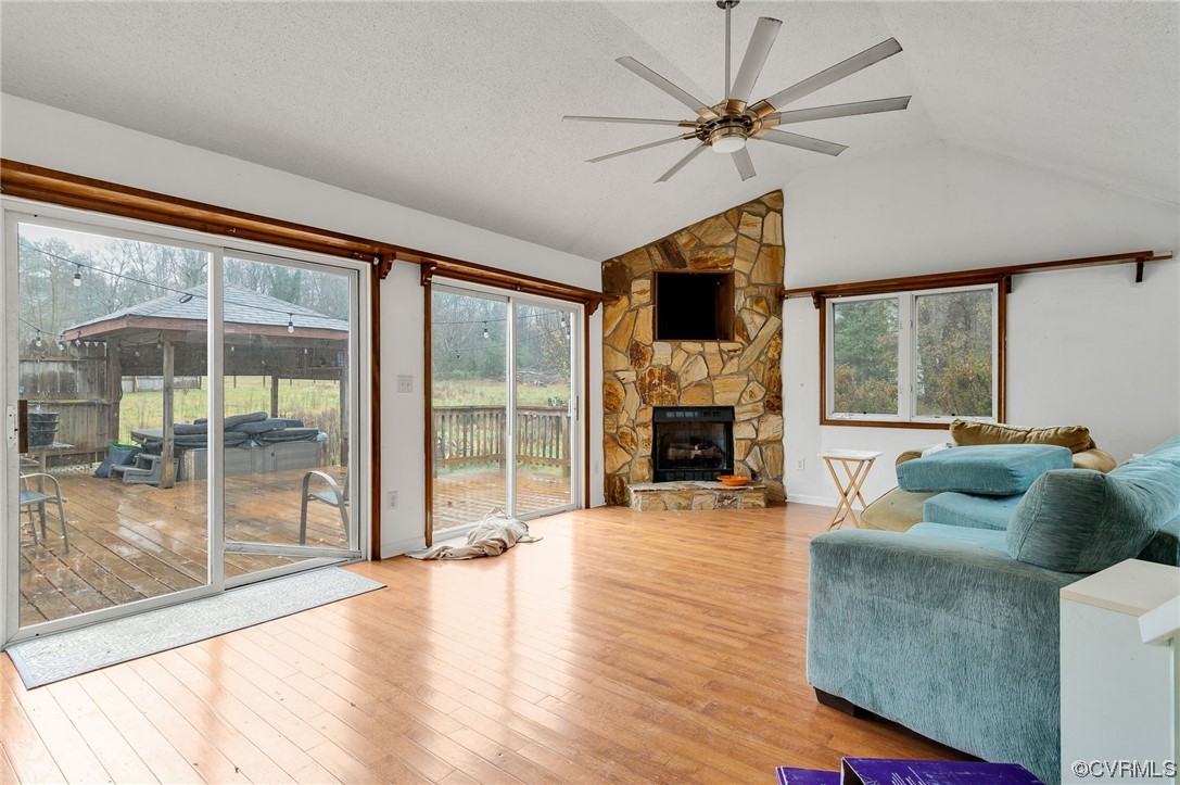 2949 Broadstreet Road Gum Spring, VA 23065 - Photo 8 of 21 a living room with furniture a fireplace and a floor to ceiling window
