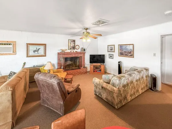 a living room with furniture fireplace and a window