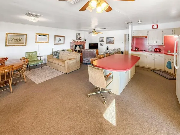 a living room with furniture a rug and a window