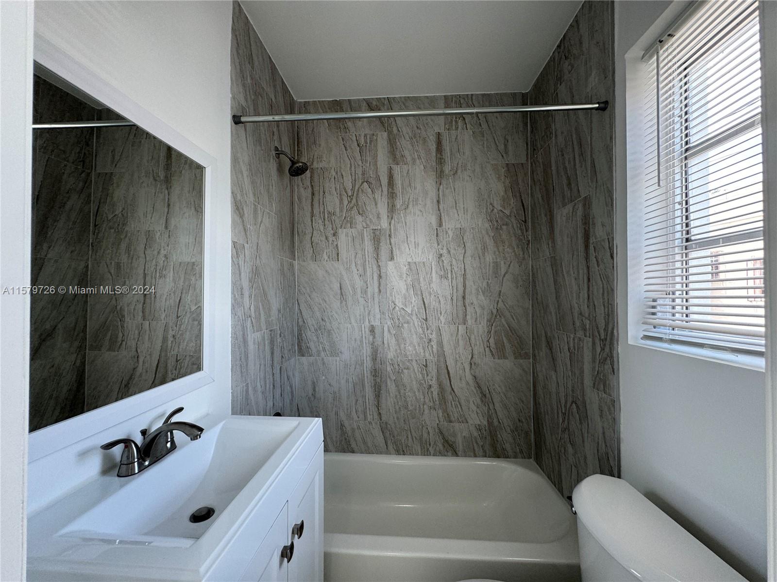 6955 Rue Vendome, Unit 2 Miami Beach, FL 33141 - Photo 14 of 21 a bathroom with a shower and a tub