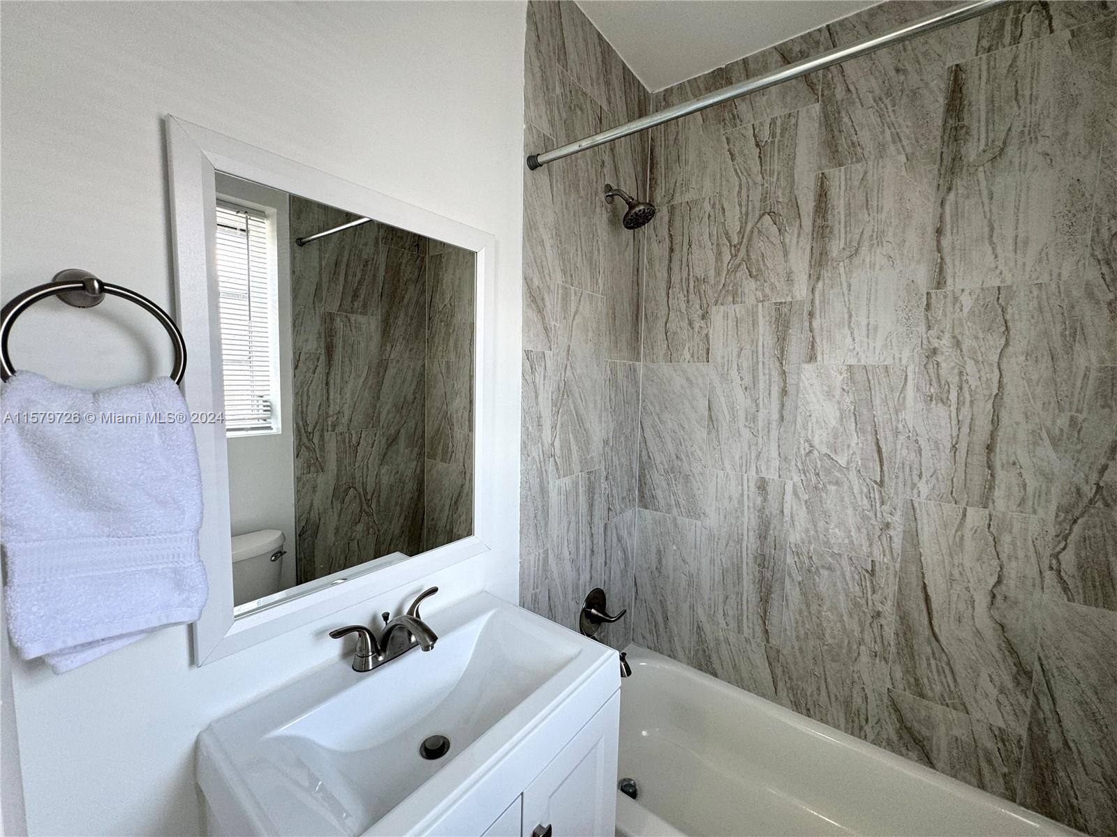 6955 Rue Vendome, Unit 2 Miami Beach, FL 33141 - Photo 15 of 21 a bathroom with a sink and a mirror