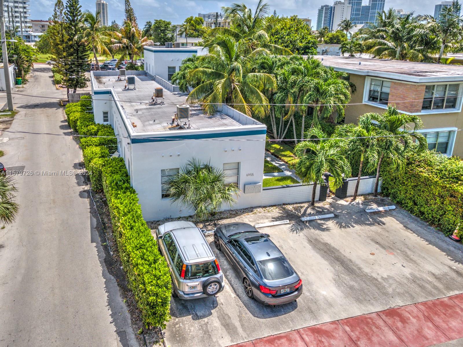6955 Rue Vendome, Unit 2 Miami Beach, FL 33141 - Photo 19 of 21 a view of a patio with table and chairs potted plants