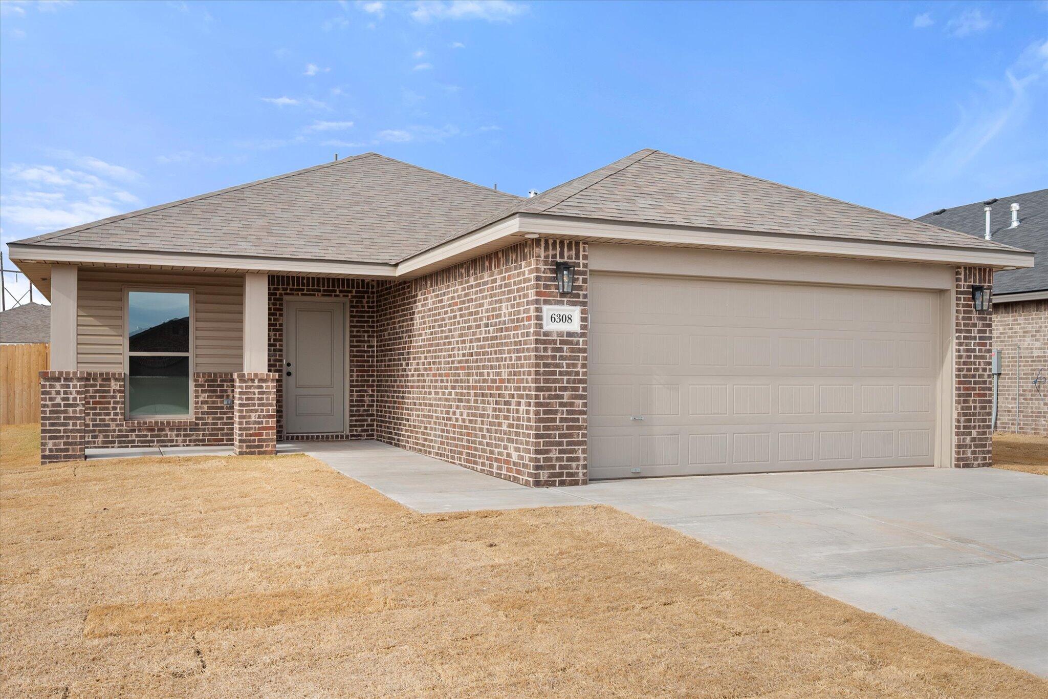 6308 Virginia Avenue Lubbock, TX 79407 - Photo 1 of 20 a front view of a house with a garage