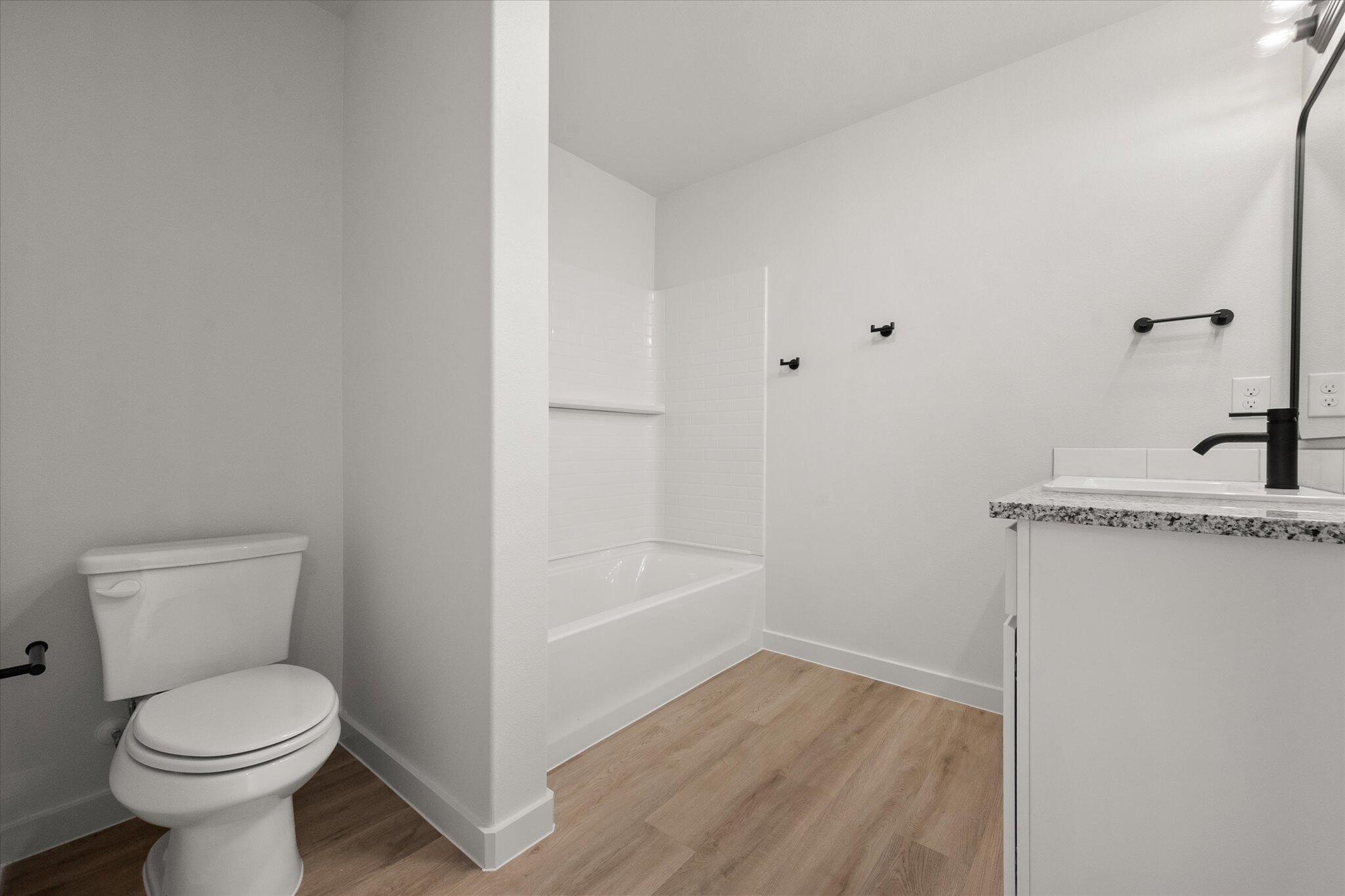 6308 Virginia Avenue Lubbock, TX 79407 - Photo 13 of 20 a bathroom with a toilet a sink and bathtub