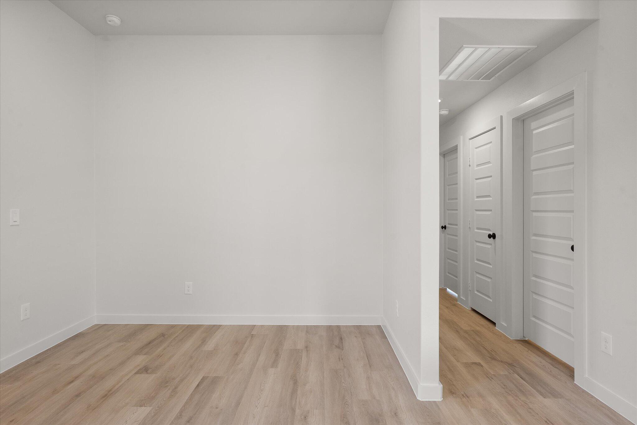 6308 Virginia Avenue Lubbock, TX 79407 - Photo 14 of 20 a view of an empty room with wooden floor