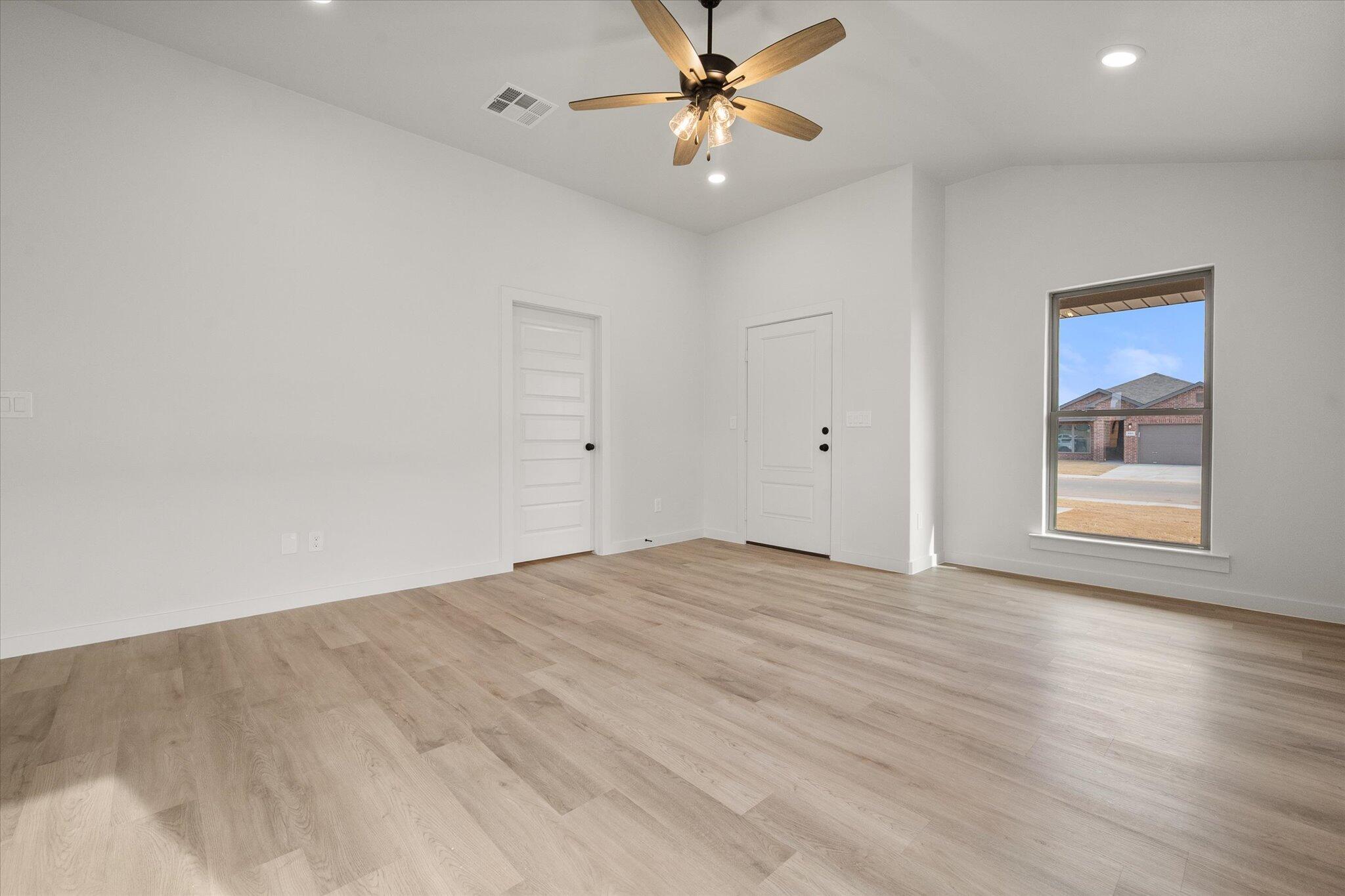 6308 Virginia Avenue Lubbock, TX 79407 - Photo 5 of 20 a view of an empty room with window and a ceiling fan