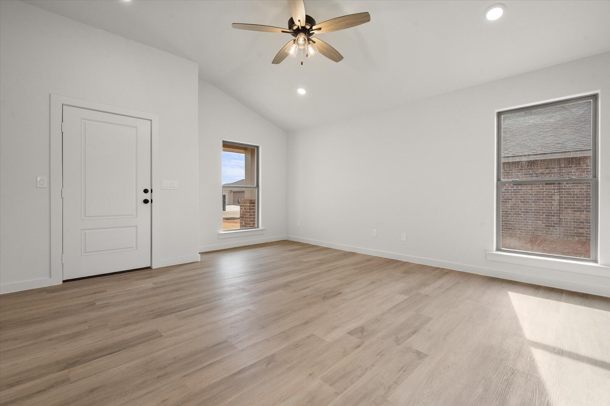 6308 Virginia Avenue Lubbock, TX 79407 - Photo 6 of 20 wooden floor in an empty room with a window