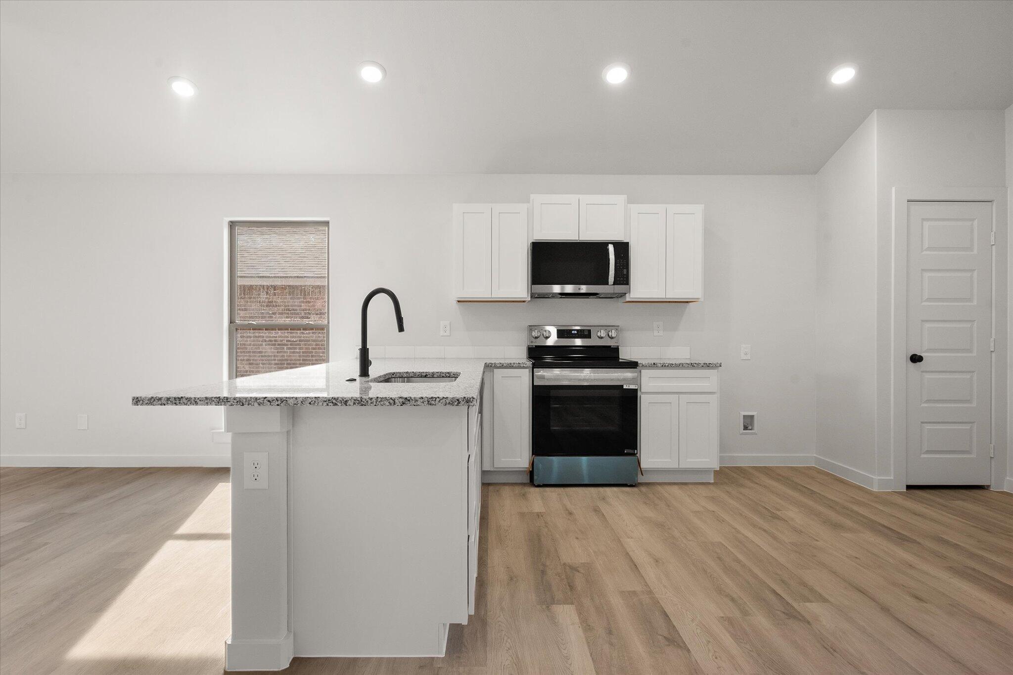 6308 Virginia Avenue Lubbock, TX 79407 - Photo 9 of 20 a kitchen with a sink and a stove top oven