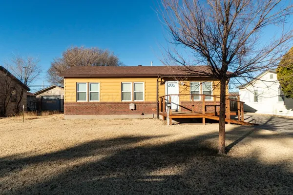 a view of a house with backyard and a patio