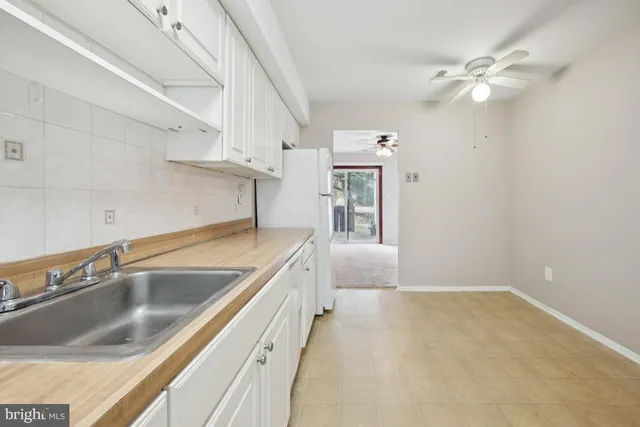 a kitchen with a sink cabinets and window