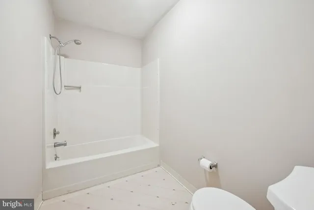 a bathroom with a toilet and a bathtub