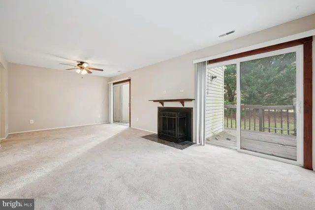 a view of a livingroom with an empty space and a fireplace