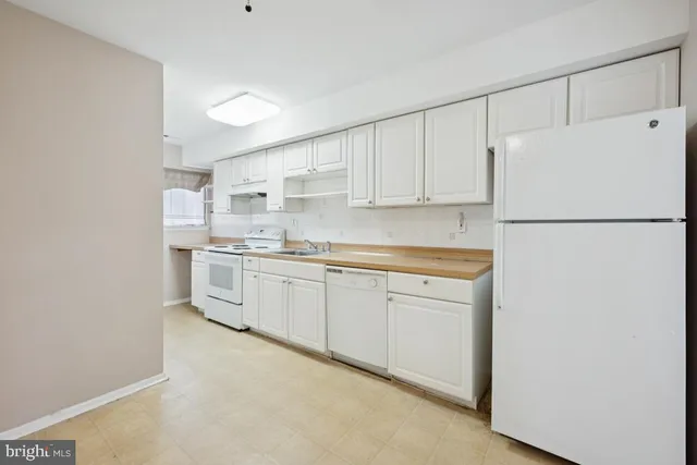a white refrigerator freezer sitting in a kitchen
