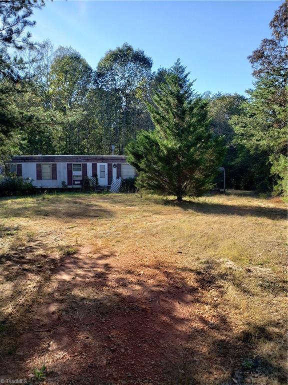 595 John Mickles Road Pinnacle, NC 27043 - Photo 2 of 20 Singlewide has dirt driveway, no electricity, well, or septic. Was run off a generator. Duke power is already servicing this road.