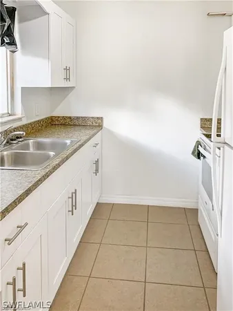a view of a kitchen with white cabinets