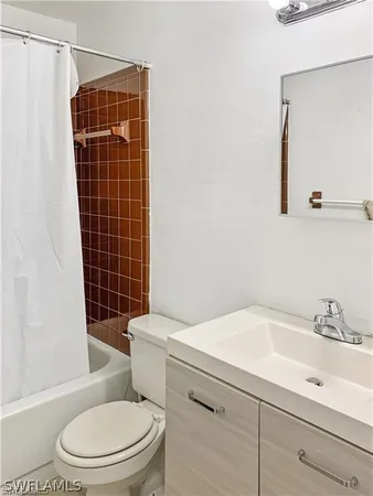 a white toilet sitting next to a bathroom sink