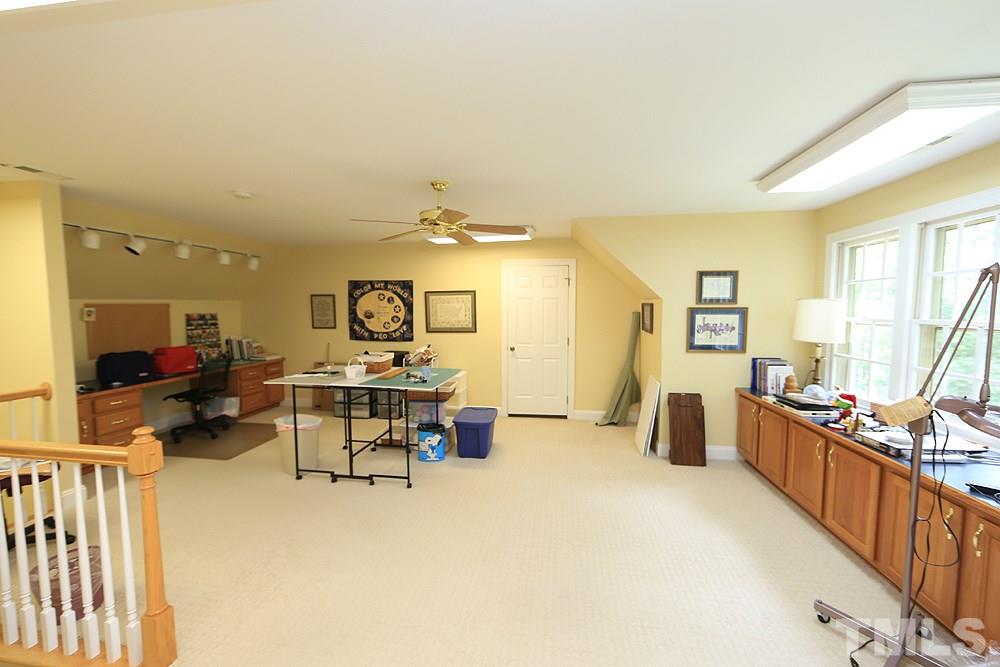 14408 Possum Track Road Raleigh, NC 27614 - Photo 21 of 25 Finished room on the third level offers lots of possibilities. Unfinished walk in storage on both sides.