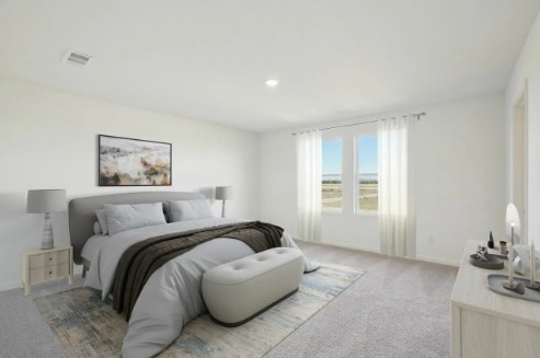 16041 Cowslip Way Austin, TX 78725 - Photo 14 of 26 a spacious bedroom with a bed a couch and large window