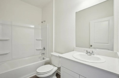16041 Cowslip Way Austin, TX 78725 - Photo 25 of 26 a bathroom with a sink a toilet and a bathtub