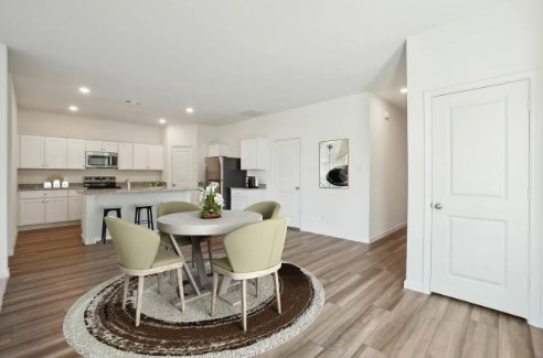 16041 Cowslip Way Austin, TX 78725 - Photo 7 of 26 a dining room with furniture and wooden floor