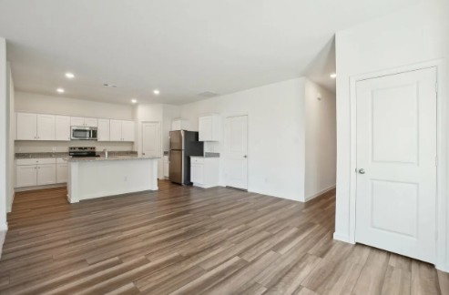 16041 Cowslip Way Austin, TX 78725 - Photo 8 of 26 a view of kitchen with wooden floor